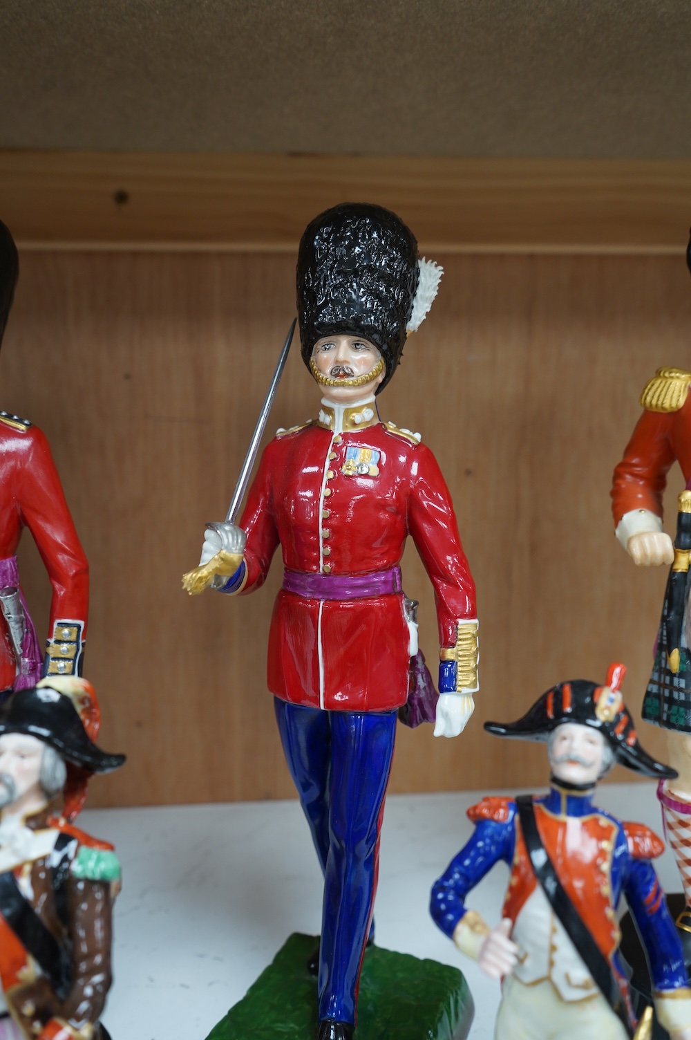 A pair of Sevres style Napoleonic figures and three others including Worcester, tallest 30cm. Condition - fair to good